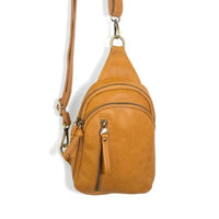 Brown faux leather Skyler Sling Bag with a convertible strap made from vegan leather