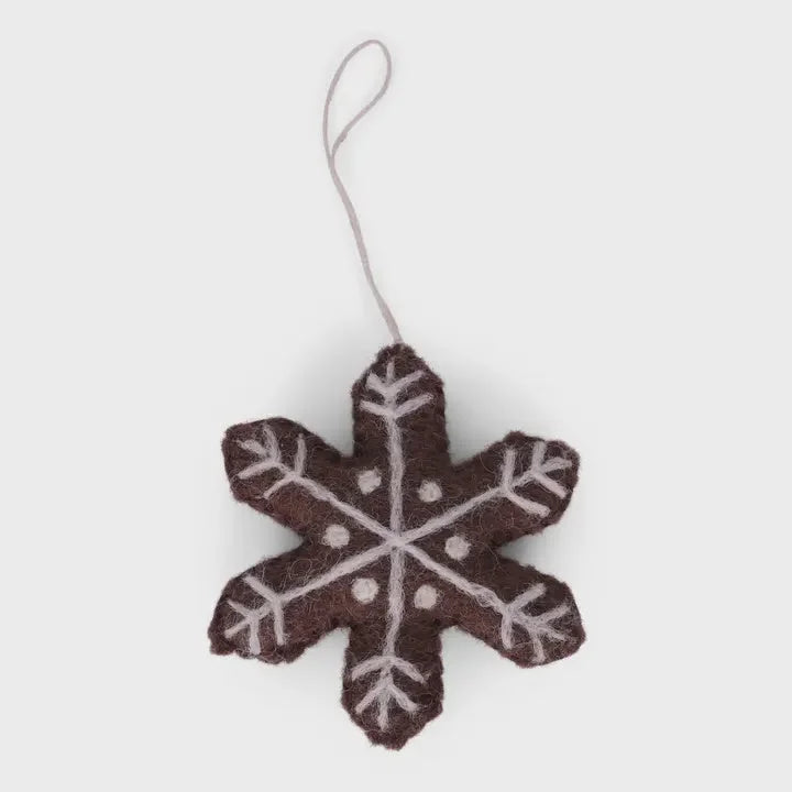 Handmade gingerbread star ornament in brown felt with white accents