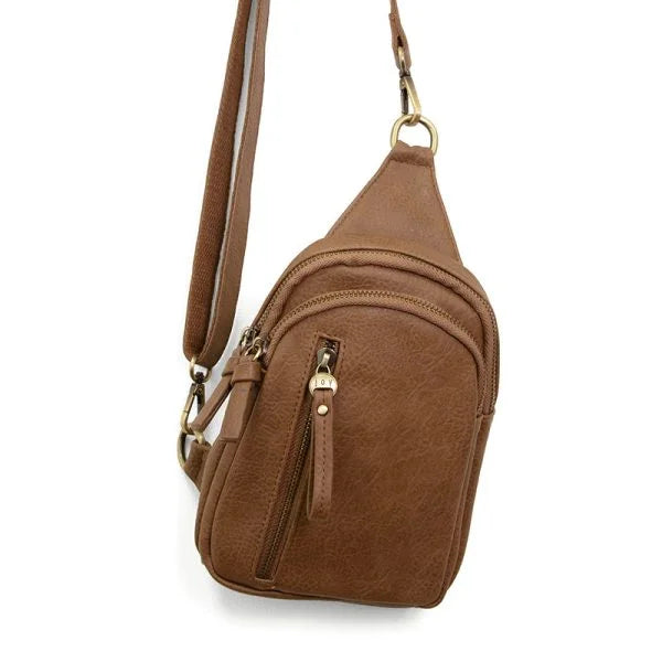 Brown leather Skyler Sling Bag featuring multiple zippered compartments and adjustable strap