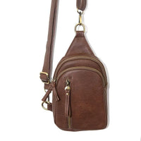 Brown leather Skyler Sling Bag featuring multiple compartments and zipper closure