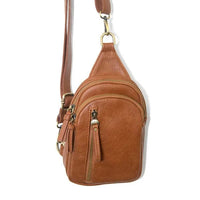 Brown leather SKYLER SLING BAG with gold hardware and floral embossing
