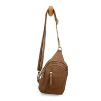 Brown leather SKYLER SLING BAG featuring multiple zippered compartments for convenience