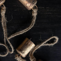 Brown leather rope bracelet with beads and barrel brass bell ornament