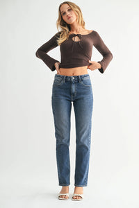 Brown long-sleeve crop top with lace-up neckline over high rise straight pencil jeans