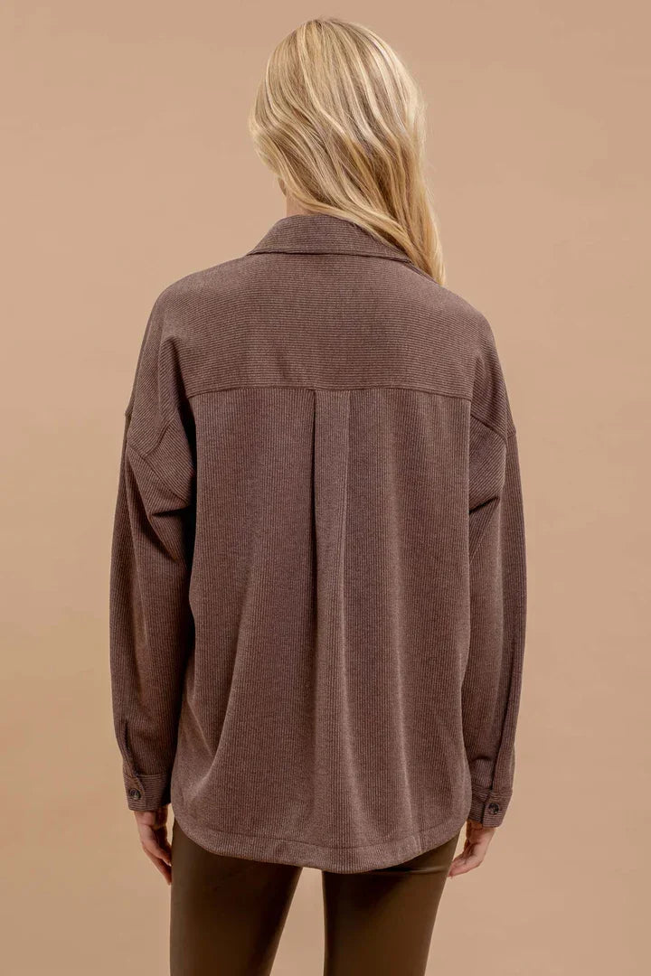 Brown oversized pinstripe button-up shirt viewed from the back for stylish layering