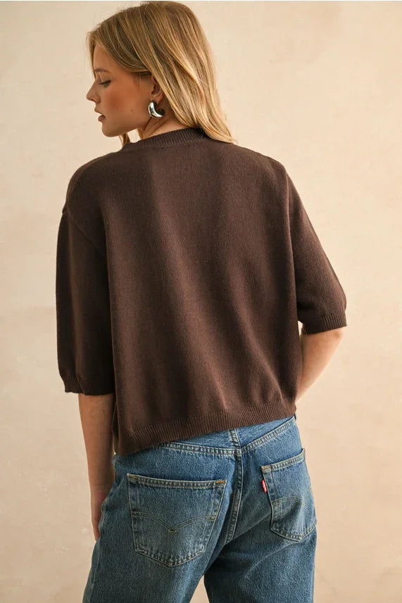 Brown short sleeve sweater top with oversized fit, rolled sleeves, and pocket