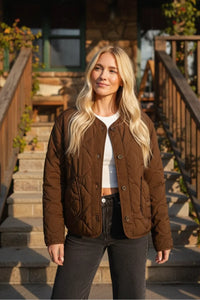 Brown padded round neck quilted jacket with white shirt and black pants