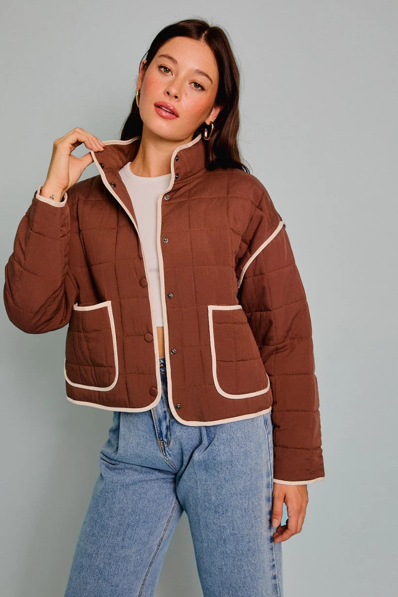 Brown drop shoulder high collared quilt jacket with white trim and patch pockets