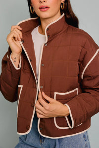 Brown drop shoulder high collared quilt jacket with cream trim and button closures