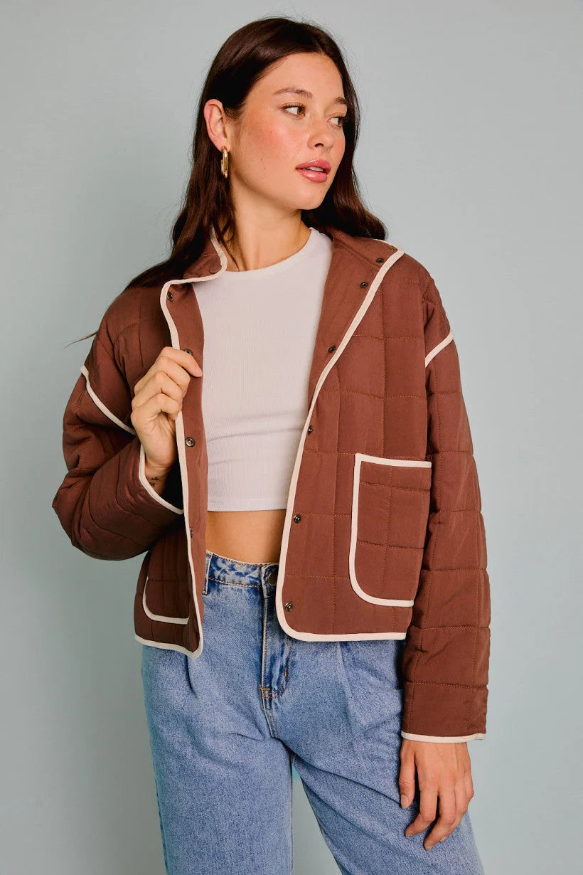 Brown drop shoulder high collared quilt jacket with white trim and contrast piping details