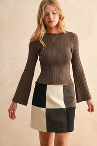 Brown ribbed long sleeve knitted top with bell sleeves paired with patchwork mini skirt
