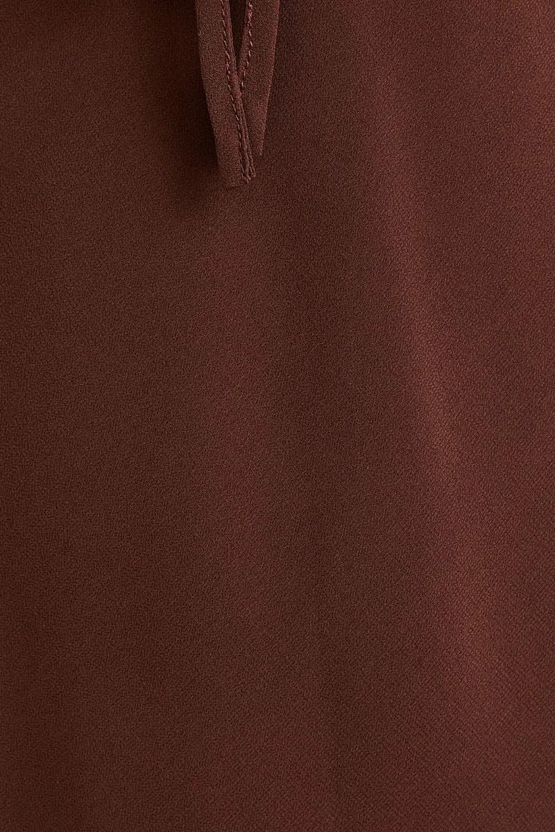 Brown silk bias maxi dress with V-neck and button collar closure