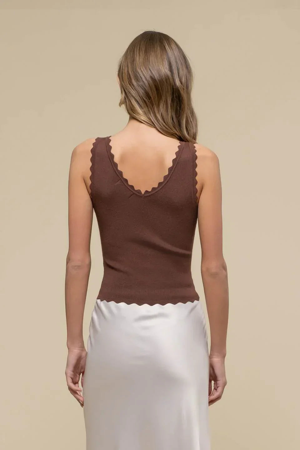 Brown scallop edge sleeveless top showcased on a model from behind