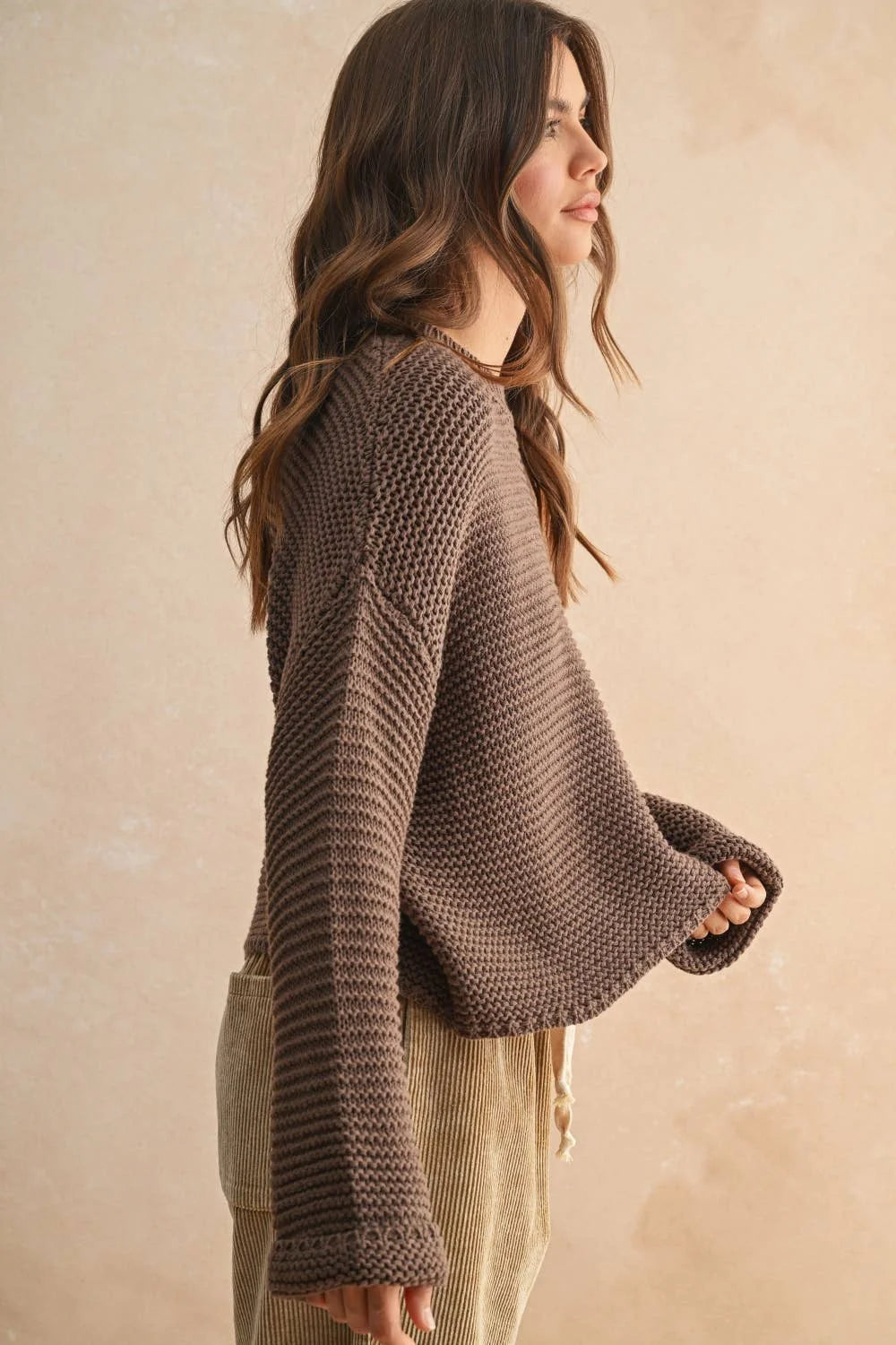 Brown round neck knitted sweater with textured bell sleeves and pocket