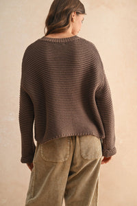 Brown round neck knitted sweater with textured fabric, corduroy pants