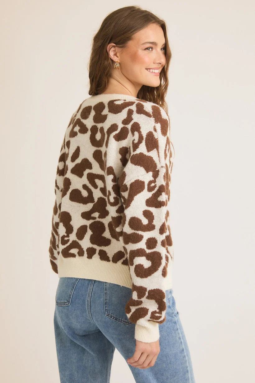 Brown and white cow print sweater with ribbed trim, ideal for women’s boho chic clothing