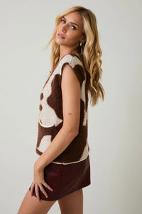 Brown and white cow print sweater vest cardigan with dark red mini skirt for stylish look