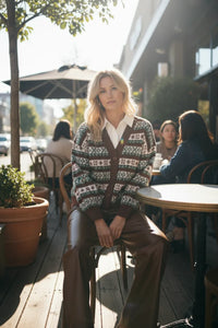 Round neck button-up graphic cardigan in brown and white pattern with leather pants