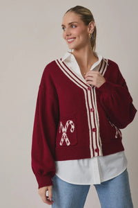 Burgundy candy cane graphic cardigan with white buttons and pockets