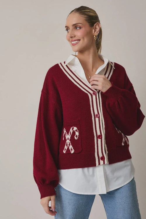 Burgundy candy cane graphic cardigan with white buttons and pockets