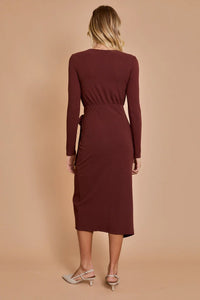 Burgundy long-sleeved midi dress worn by a woman, ideal for women’s boho chic clothing