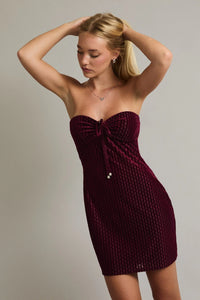 Burgundy strapless velvet mini dress with textured pattern and front buttons