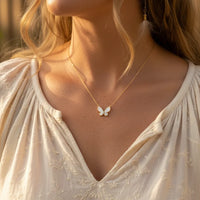 Butterfly necklace with gold chain and white enamel wings from GOLD WINGS PEARL collection