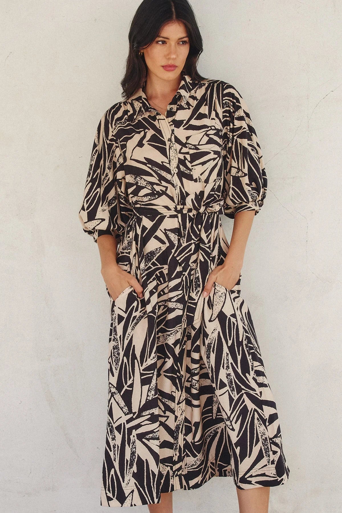 Button-down midi shirt dress with black and white leaf print and puff sleeves. Shop Daisy