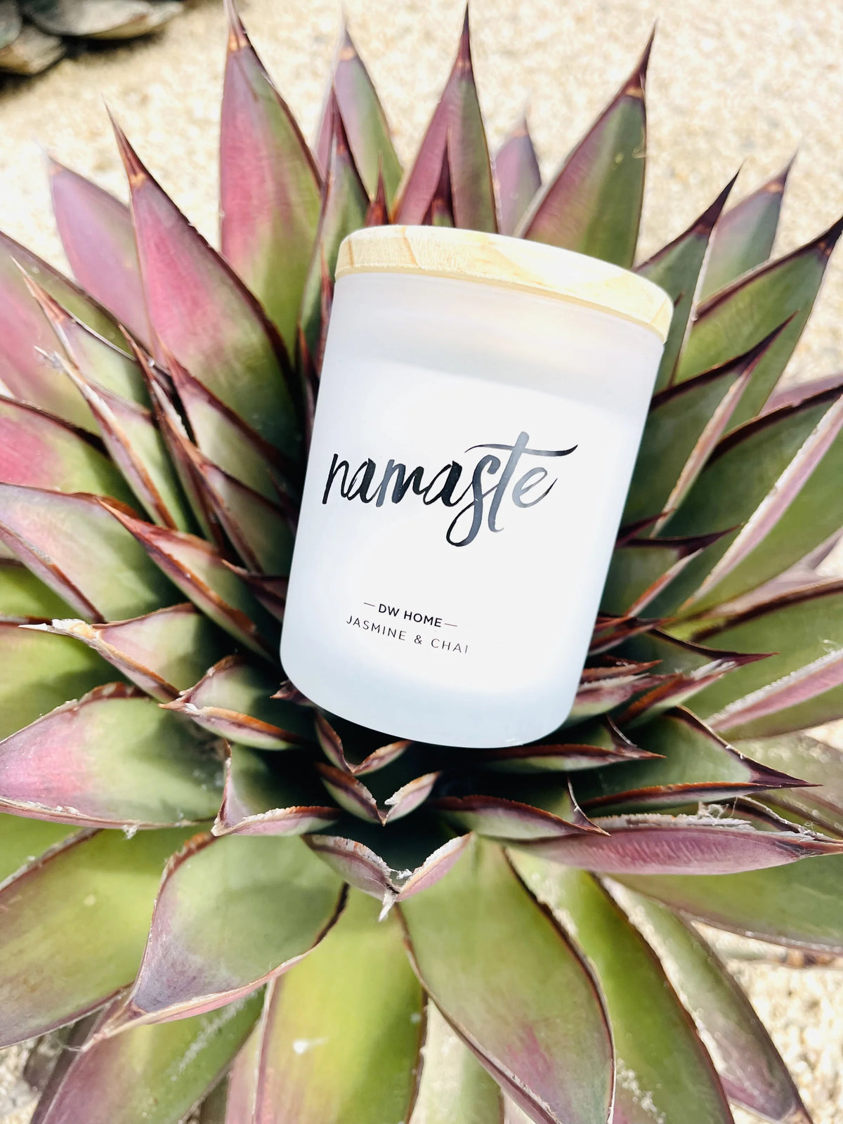 Candle featuring the word Nam in the Namaste Jasmine & Chai Mini Candle product