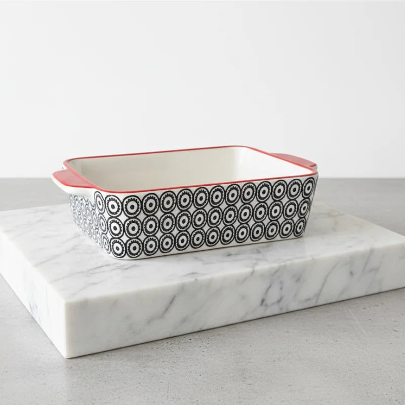 Hand Stamped Stoneware Baker with black white patterns red rim on marble