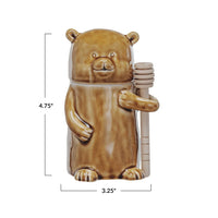 Ceramic honey jar with wood dipper in brown and tan glaze, ideal for women’s boho chic clothing
