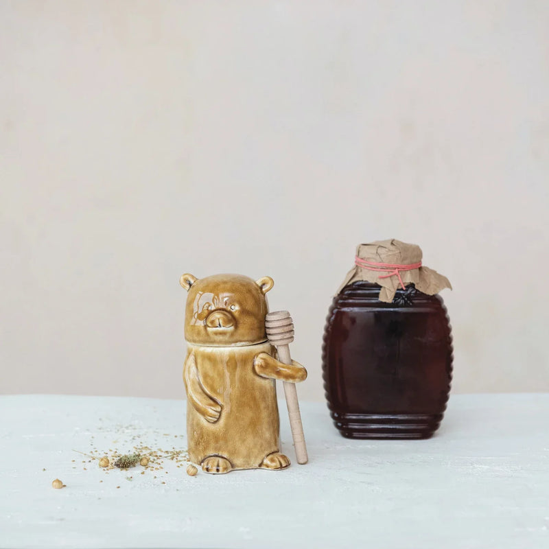 Ceramic honey jar with wood dipper in brown and tan glaze, ideal for women’s boho chic clothing
