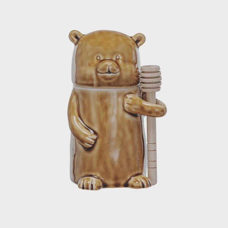 Ceramic honey jar with wood dipper in light brown, ideal for women’s boho chic clothing