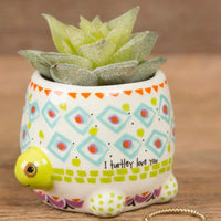 Tiny faux succulents in ceramic turtle planter with boho patterns