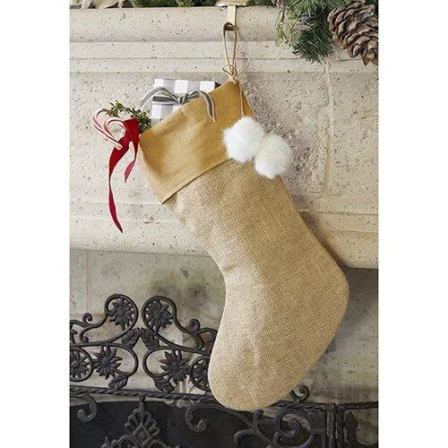 Beige jute holiday stocking with white fur trim and festive decorations for a rustic look