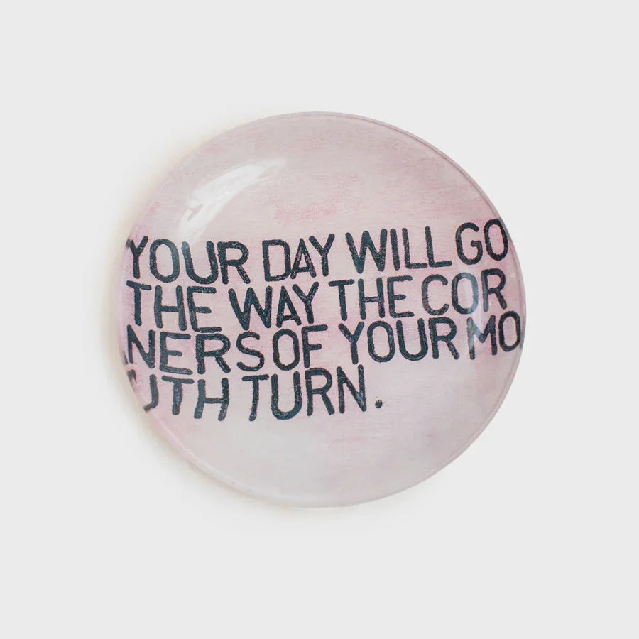 Round decoupage plate featuring a motivational message in black text