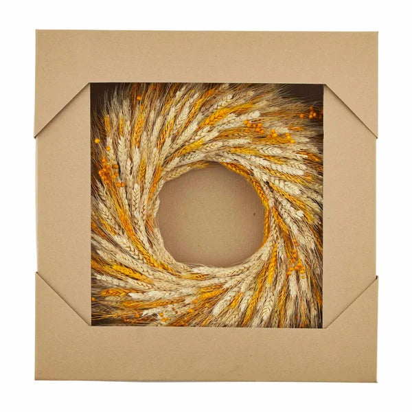 Circular wheat wreath adorned with golden wheat stalks and autumn leaves for fall decor