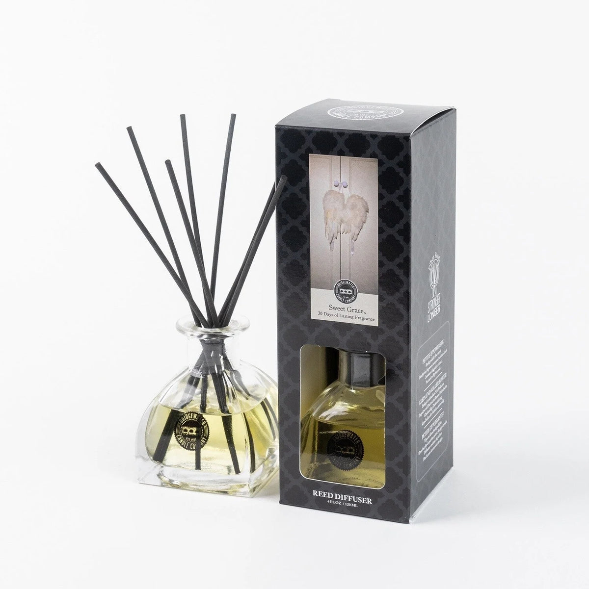 Close up of PETITE REED DIFFUSER SWEET GRACE with reeds and a perfume bottle