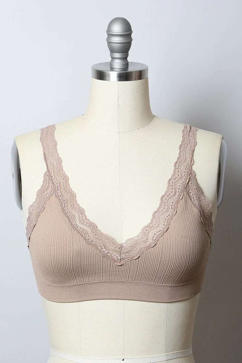 Close up of a dress form showcasing the Lace Trim Padded Bralette, embodying feminine elegance