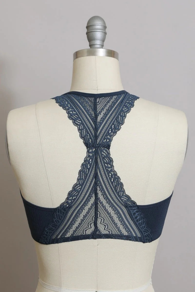 Close up of a dress on a mannequin featuring a Lace Racerback Bralette design