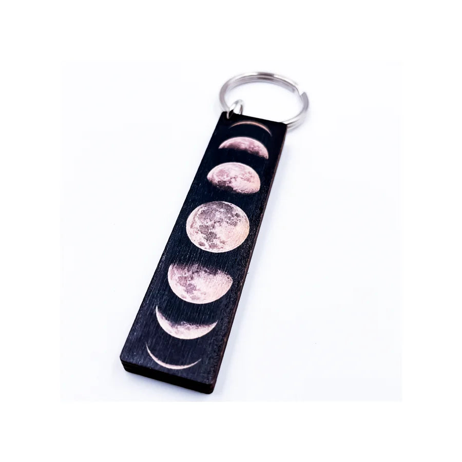 Close up of a Moon Phases Wooden Key Chain featuring three moon designs