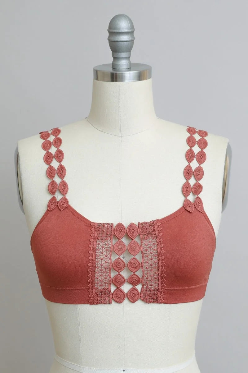 Close-up of a mannequin showcasing the Bohemian Eye Lace Applique Bralette in red