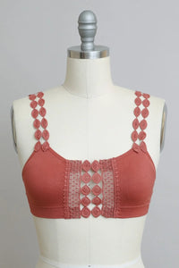 Close-up of a mannequin showcasing the Bohemian Eye Lace Applique Bralette in red