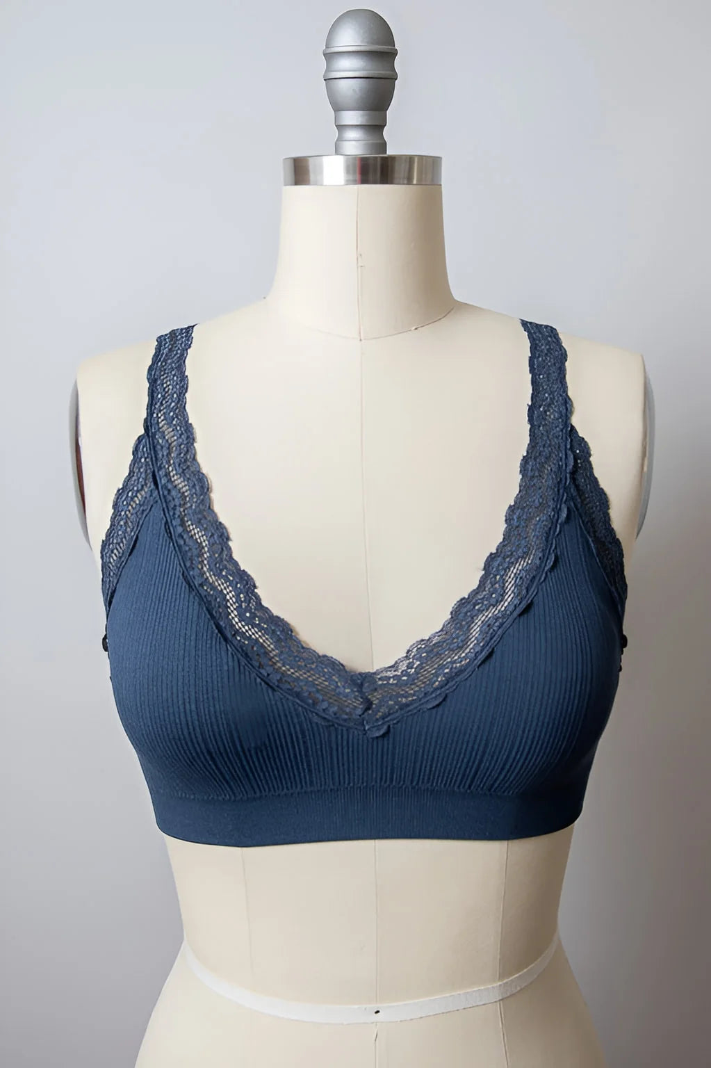 Close-up of a mannequin torso showcasing a Lace Trim Padded Bralette, exuding feminine elegance