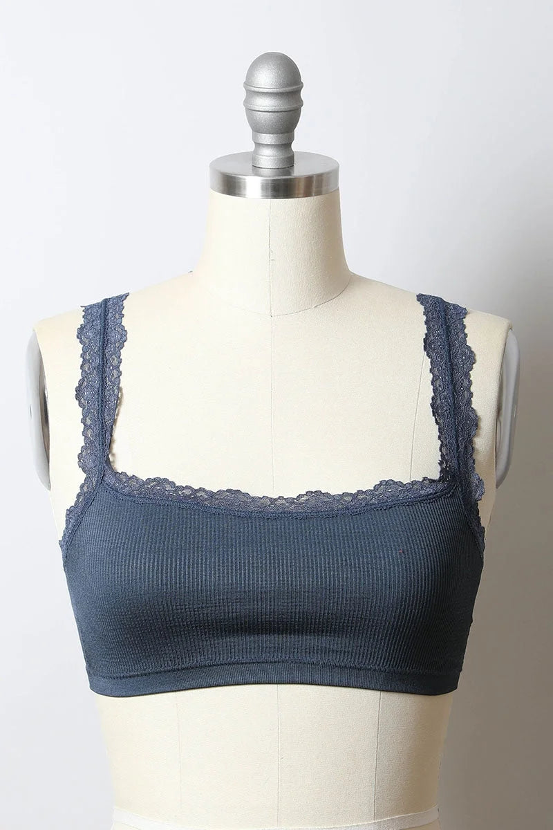 Close up of a mannequin torso showcasing the Seamless Lace Strap Bralette in blue