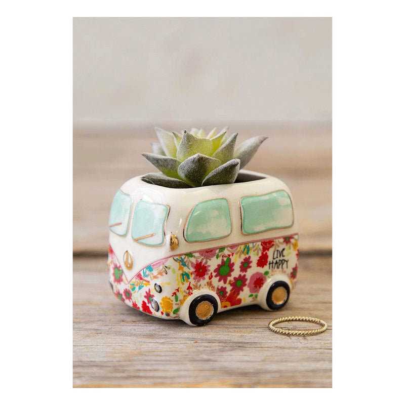 Close-up of CAMPER FAUX SUCCULENT with a small bus on a charming planter