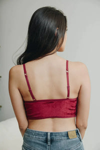 Close-up of a woman in a red lace boho half cami and jeans for stylish fashion