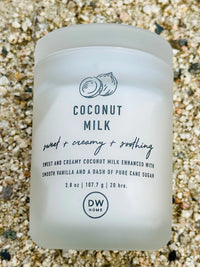 Coconut Milk Body Scrub beside COCONUT MILK MINI CANDLE in a boho setting