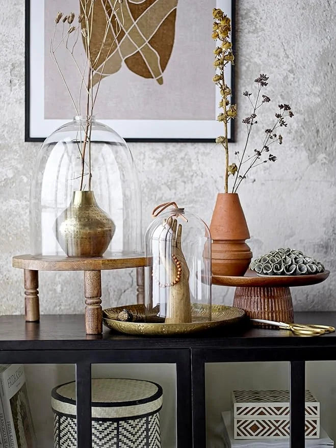 Collection of decorative hammered metal finish vases and containers on a table