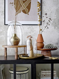 Collection of decorative hammered metal finish vases and containers on a table